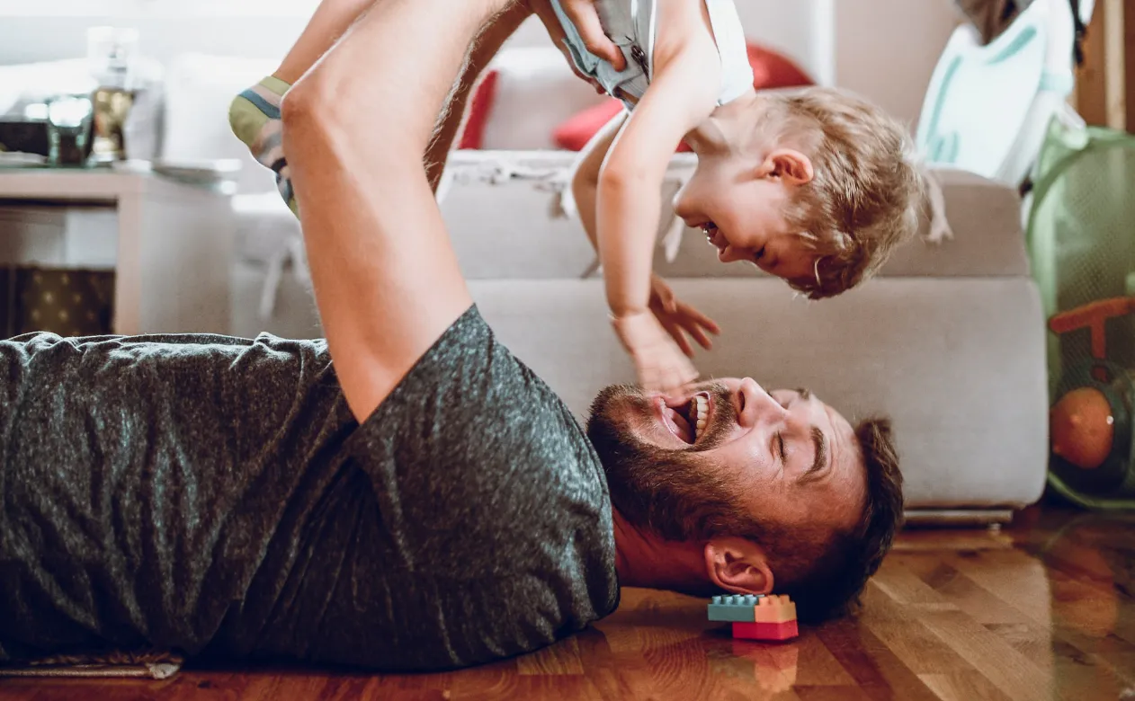 Father and son playing on floor