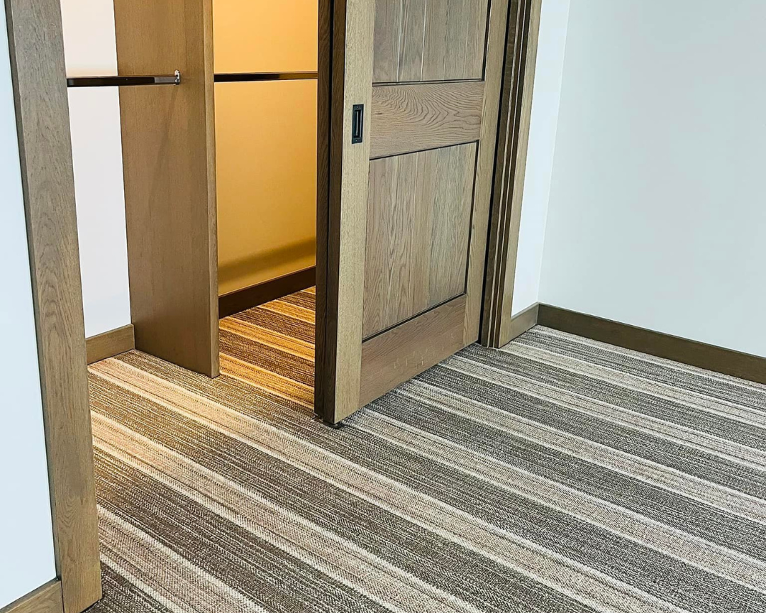 Carpet installation in bedroom with closet